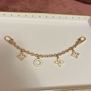 White and gold bag charm